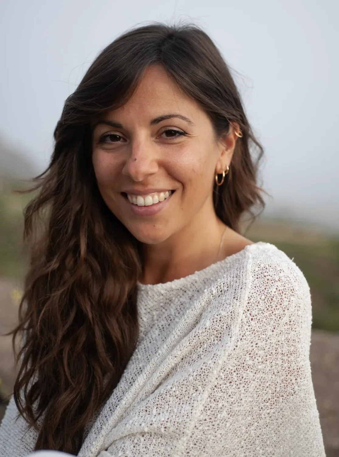 Malù, founder of Embodika, smiling outdoors